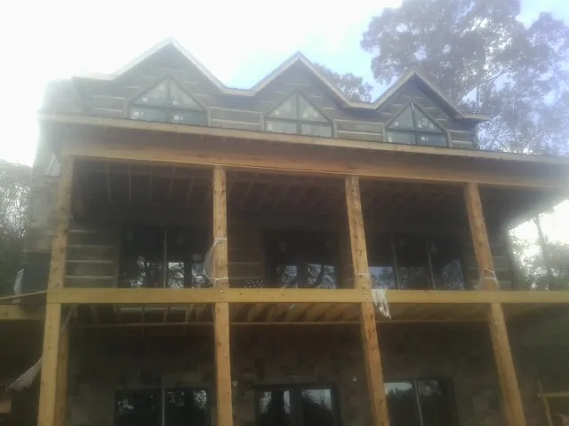 Dormers and porch framing on a large log home under construction — Roof Coating work by our crew in Rockhill Furnace