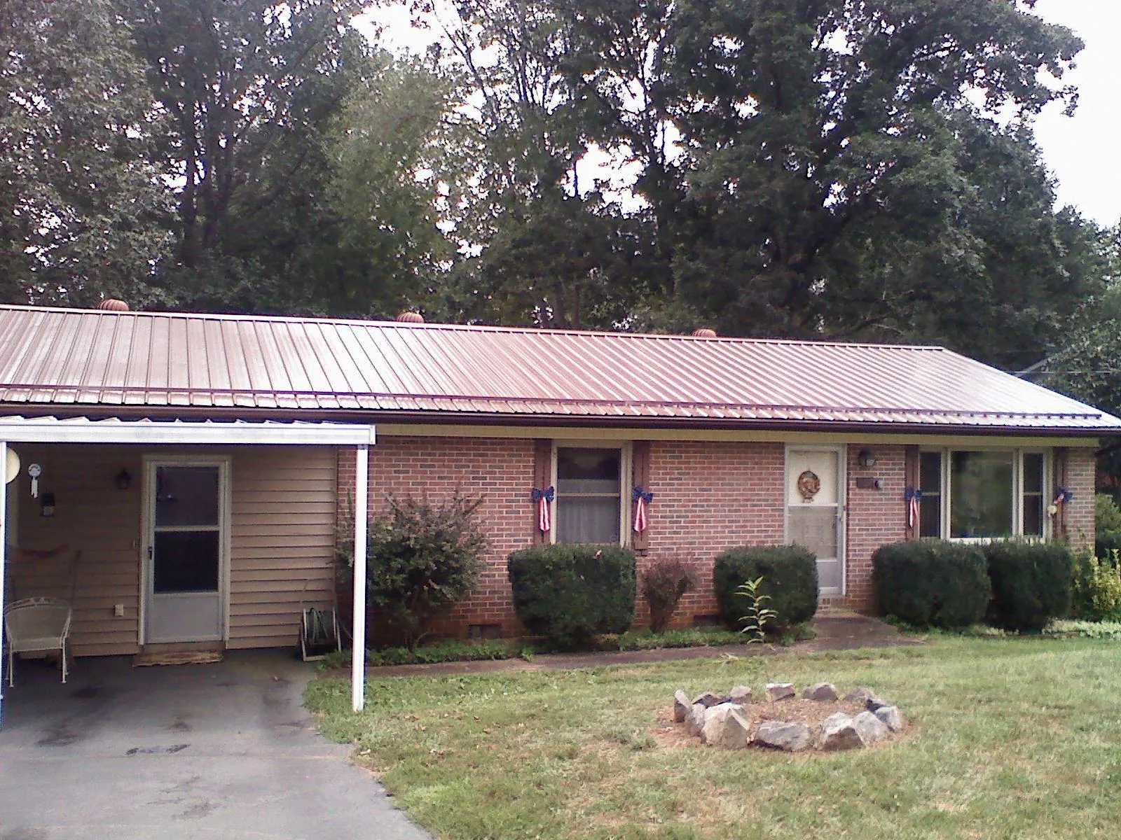 Bronze metal roof and carport on a brick ranch home — Roof Repair work by our crew in Rockhill Furnace