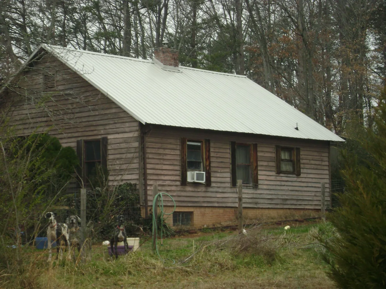 White metal roof on an old wood sided farmhouse, from a Asphalt Shingle Roof Repair job in Rockhill Furnace